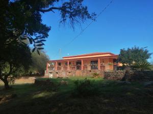 a house with a fence in front of it at Agriturismo Conca' e Janas in Dorgali