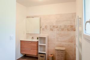 un bagno con lavandino e specchio di La Villa Adoé a Vallon-Pont-dʼArc Altre 18 foto