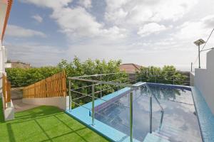 a swimming pool on the roof of a house at clemente house,private pool in Arafo