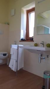 a bathroom with a sink and a toilet and towels at Country House Poggio Alto in Buonabitacolo