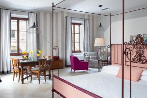 a bedroom with a bed and a dining room at BorgoDeGreci Apartments in Florence