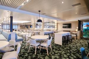 a dining room with tables and chairs and a tv at Tallink ferry - Baltic Queen Tallinn to Stockholm in Tallinn