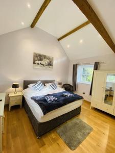 a bedroom with a king sized bed in a attic at The Stable - For A Unique Retreat in Hooe
