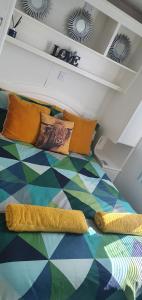 a bed with colorful pillows on it in a room at The Hummingbird in Clitheroe