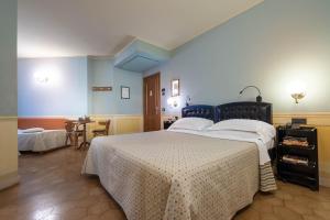 a bedroom with a large bed and a table at Hotel San Luca in Spoleto