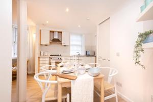 a kitchen with a table and chairs in a kitchen at ALTIDO Gorgeous Old Town Flat in Edinburgh