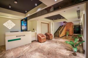 an office lobby with a reception desk and stairs at Townbridge Hotels & Suites in Cochin