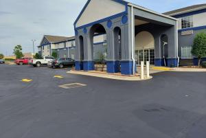 a parking lot in front of a building at Days Inn & Suites by Wyndham Huntsville in Huntsville