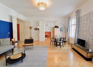 a living room with a couch and a table at Beautiful Flat Next to Karlskirche in Vienna