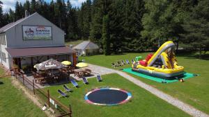 a playground with a inflatable slide in the grass at Penzion Šumavous in Vimperk