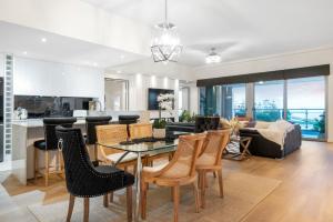 a living room with a table and chairs at Suite 3201 Three Bedroom Luxe Oceanview Apartment in Mandurah