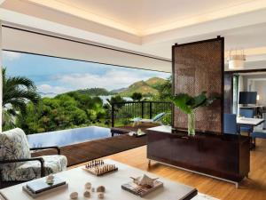 a living room with a view of the ocean at Raffles Seychelles in Baie Sainte Anne