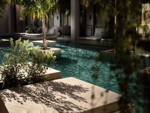 a swimming pool with blue water in a building at Contessina Hotel in Tsilivi