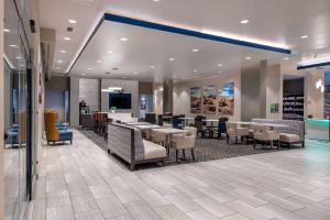 a restaurant with tables and chairs in a lobby at La Quinta Inn & Suites by Wyndham Holbrook Petrified Forest in Holbrook