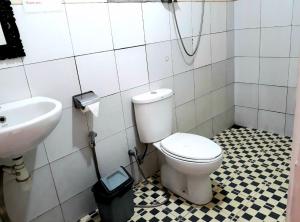 a bathroom with a toilet and a sink at One Homestay and Warung in Munduk