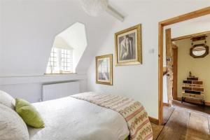 a bedroom with a bed and a clock on the wall at 14th Century Medieval Longhouse 
