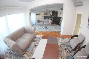 a living room with two couches and a table at Luxury Marina View Apartment Izola in Izola