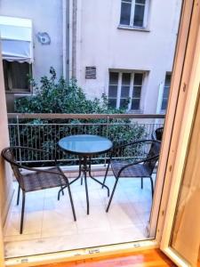 a patio with a table and chairs on a balcony at Lovely apartment in Athens center in Athens