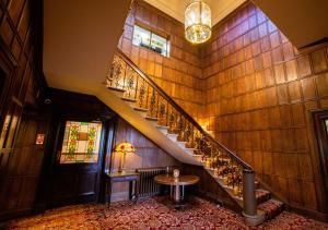 a staircase in a building with a table in a room at The Upper House in Stoke on Trent