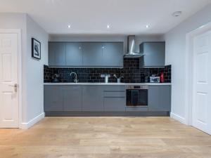 a kitchen with a sink and a counter top at Howick House - Large 3 bedroom house, Gosforth in Kenton +19 photos