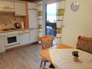 eine Küche und ein Esszimmer mit einem Tisch und einem Fenster in der Unterkunft Ferienwohnung Wenzl in Zandt