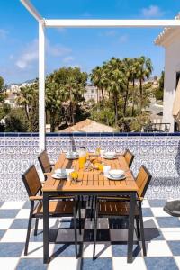 a wooden table with chairs sitting on a patio at Oasis 16 in Nerja