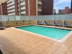 a swimming pool on the roof of a building at Oceanic View in Durban