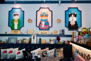 a room with four pictures of cats on the wall at Perennial Resort in Nai Yang Beach