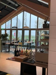 a tasting room with bottles of wine on a table at Panoramatent, in de natuur aan zee in Callantsoog