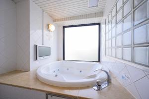 a large white tub in a bathroom with a window at Water Hotel Mw 岩槻 -Adult only- Love Hotel in Saitama +142 photos