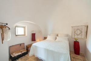 Uma cama ou camas num quarto em Trulli 18cinquantanove