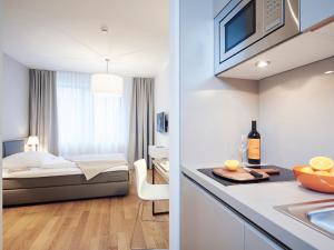 a hotel room with a bed and a kitchen at ipartment Frankfurt City Centre in Frankfurt/Main