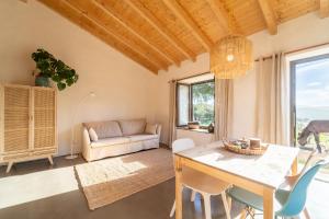 ein Wohnzimmer mit Tisch und Stühlen und einer Couch in der Unterkunft Casa da Paz in Aljezur
