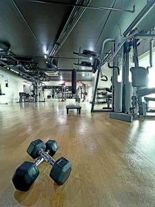 a gym with dumbbells laying on the floor at The Beacon Residences Condominium in Manila