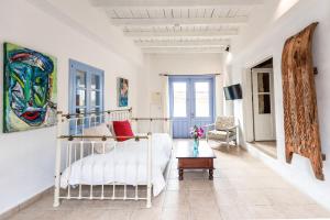 a white room with a bed and a couch at Cyprus Villages Hotel & Restaurant - Central Location - Bed & Breakfast - With Access To Pool And Stunning Views in Tochni