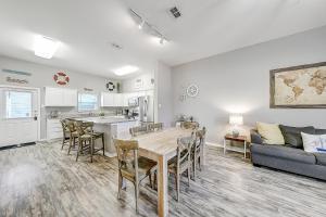 a kitchen and living room with a table and a couch at Beach Way Mermaid Cove in Padre Island