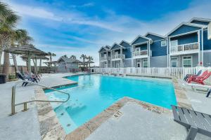 a swimming pool in front of a villa at Beach Way Mermaid Cove in Padre Island