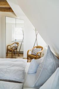 a bedroom with a bed and two chairs at Wohnen auf Zeit in Weingarten in Weingarten
