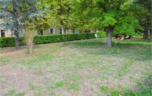 a park with two red benches and trees at Awesome Apartment In Rustrel in Rustrel +16 photos