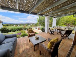 a patio with a couch and chairs and a table at Chalcedony in McGregor