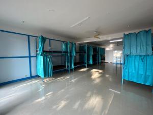 an empty room with blue curtains in a room at Soul, Varkala - Black Beach in Varkala