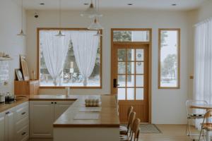 a kitchen with a table and a large window at Panju Homestay in Hualien City