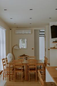 a dining room with a wooden table and chairs at Panju Homestay in Hualien City