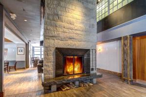 a fireplace in the middle of a room at The Woods Village 1 in Killington