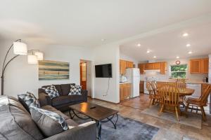 a living room with a couch and a table at Sandy Beach at Cocolalla in Cocolalla