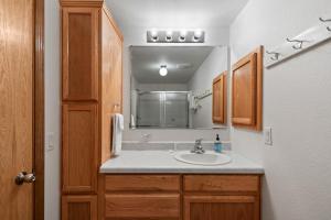 a bathroom with a sink and a mirror at Sandy Beach at Cocolalla in Cocolalla