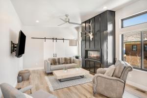 a living room with two chairs and a fireplace at Sunlight Retreat in Steamboat Springs