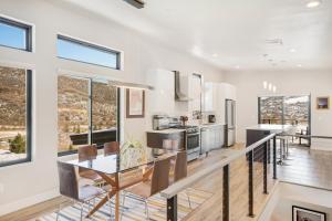 a dining room and kitchen with white walls and windows at Sunlight Retreat in Steamboat Springs