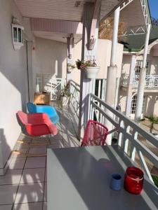 a balcony with a table and chairs on a house at CASABINA Appartement entre Disney et paris in Chelles