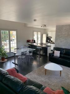 a living room with a couch and a table at CASABINA Appartement entre Disney et paris in Chelles